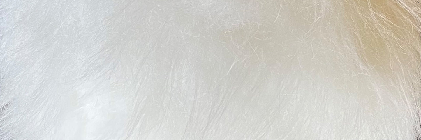 A close-up of TellTails Bunny captures the intricate, fluffy white texture resembling fur or eco stuffing, highlighting delicate strands that create a light and airy appearance.