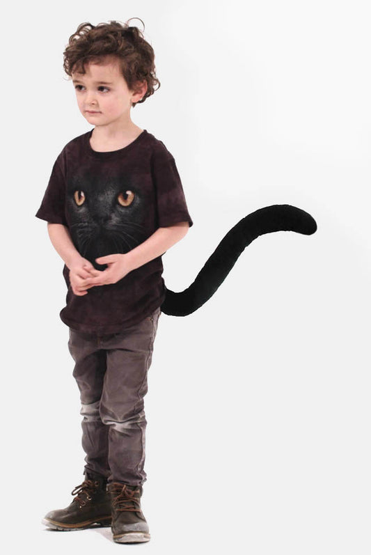 A young child sports TellTails The Black Cat t-shirt, featuring a cats face design and an attached plush tail, perfect for festivals or fancy dress. Set against a white background, this charming accessory shines.
